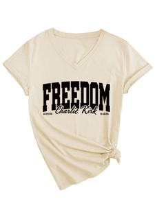 Close-up of cream V-neck T-shirt featuring freedom text and stylish front knot detail