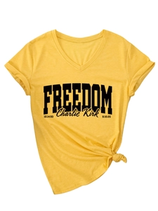 Yellow V-neck T-shirt detail showing rolled sleeves and Freedom Charlie Kirk print
