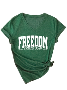 Detail of V-neck dark green t-shirt with Freedom Charlie Kirk print and knotted hem
