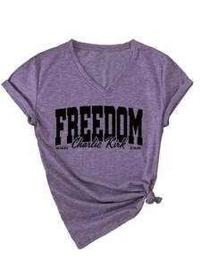Detail of purple V-neck T-shirt with Freedom print and stylish front knot hem