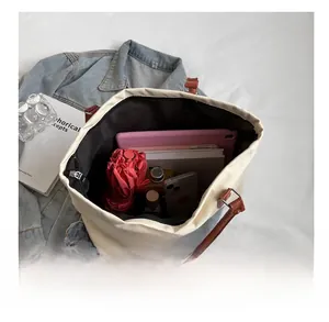 Top view of spacious canvas tote bag showing inner pockets and organized personal items