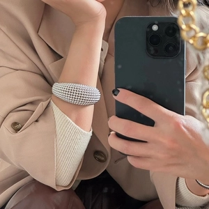 Statement silver textured bead cuff bracelet styled with a minimalist beige blazer