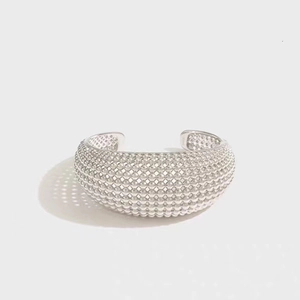 Silver hollow beaded cuff bracelet with textured mesh design for a modern minimalist look