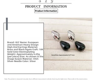 Detail view of water drop black agate earrings on beige velvet tray with size specs