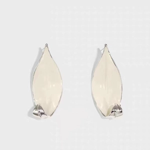 Leaf-shaped silver needle earrings with white enamel finish in minimalist modern style