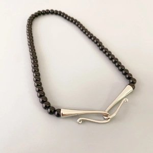 Collier de perles en onyx noir avec grand fermoir crochet argenté sculptural