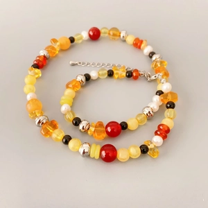 Handmade necklace with natural agate pearls and colorful mixed beads in a spiral layout
