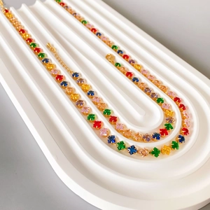 Colorful zircon 18K gold plated necklace with rainbow square-cut gemstones on display