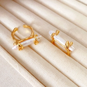 Baroque pearl ring with golden metal frame in a minimalist adjustable open design