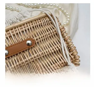 Detail of hand-woven rattan bag with leather trim and cotton drawstring lining