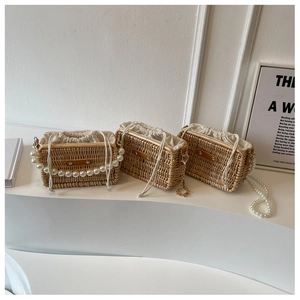 Detail of mini straw bags with pearl handles and canvas liners for vacation