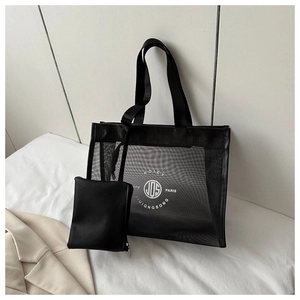 Detail of black mesh tote bag set with inner pouch and white circular logo print