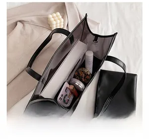 Detail view of large PVC tote bag interior with organized items and inner pouch