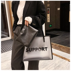 Detail of PVC tote bag and inner leather pouch with SUPPORT lettering on marble floor