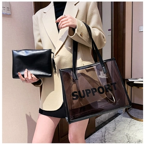 Detail view of transparent brown PVC tote bag with black inner pouch and Support print