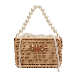 Retro woven straw bag with pearl bead handle and drawstring lining for beach vacation