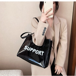 Modern black transparent PVC tote bag with Support print carried by a model