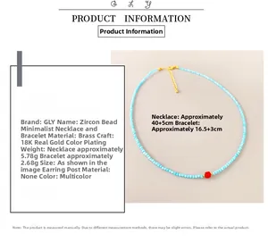 Detailed view of beaded necklace with blue stones and hexagonal red bead in 18K gold finish