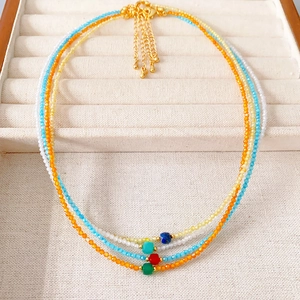 Set of four colorful beaded necklaces with zircon pendants and gold plated clasps