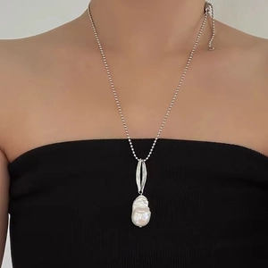 Elegant baroque pearl pendant necklace with silver bead chain shown on a model