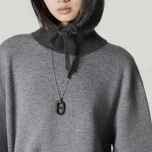 Retro wood pig-nose pendant necklace styled with grey knitwear and balaclava
