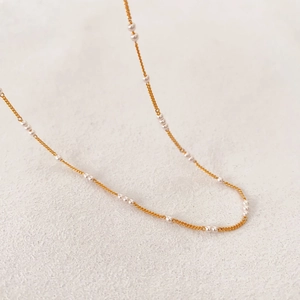 Minimalist brass gold-plated chain necklace featuring delicate small pearls for women