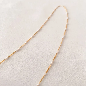 Elegant gold plated brass necklace with handmade small pearls on a minimalist thin chain