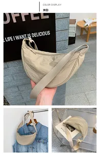 Detail of off-white nylon crescent crossbody bag with adjustable wide shoulder strap