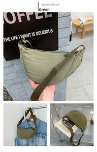 Close-up of green crescent crossbody bag showing crinkled nylon fabric and adjustable strap