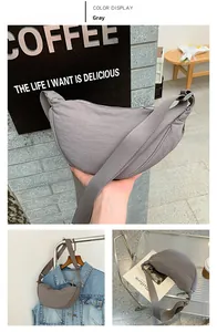 Detailed views of gray nylon half-moon crossbody bag with adjustable strap and zipper