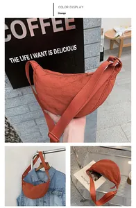 Detailed close-up of an orange nylon crescent bag with adjustable wide shoulder strap