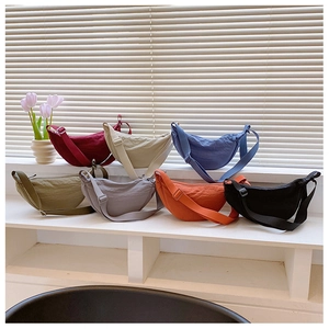 Collection of nylon crescent bags in multiple colors with adjustable shoulder straps