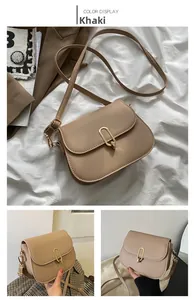 Detail view of khaki PU leather crossbody bag with golden oval U-shaped metal lock