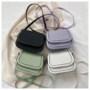Flat lay of four woven texture saddle bags in black, purple, green and white colors