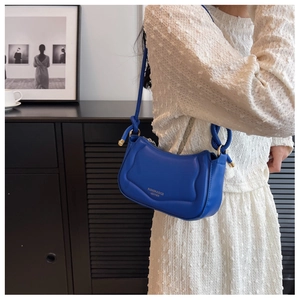 Detailaufnahme der blauen gesteppten Hobo-Tasche mit Lederriemen getragen von Model