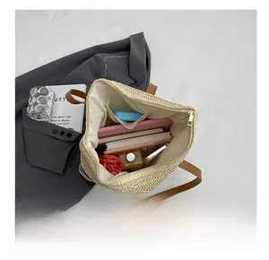 Internal view of the woven straw tote bag showing spacious capacity and inner pocket