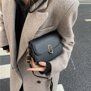 Classic black saddle crossbody bag with a gold metal buckle and adjustable strap
