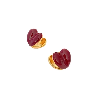 Elegant gold earrings featuring polished double-sided burgundy red heart-shaped pendants