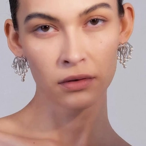 Fountain style pearl tassel drop earrings with 925 silver needle worn by a model
