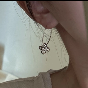 Minimalist silver hoop earrings with a four-bead cluster pendant shown on model