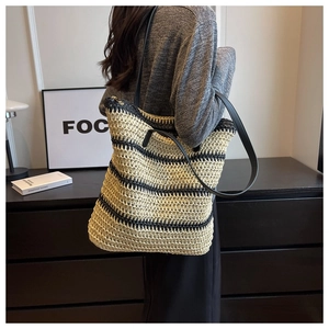 Detail of the woven texture and black contrast stripes on this summer tote bag