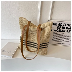 Detail of woven tote bag with black stripes, leather handles and zip closure
