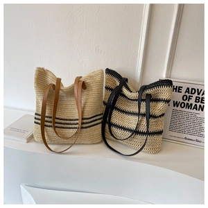Detail of woven straw tote bags with leather straps and retro striped patterns