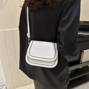 White woven saddle bag with black trim, minimalist shoulder bag for business women