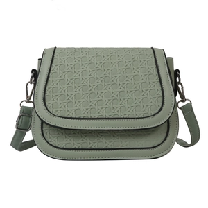 Sage green saddle bag with woven texture and silver hardware on white background