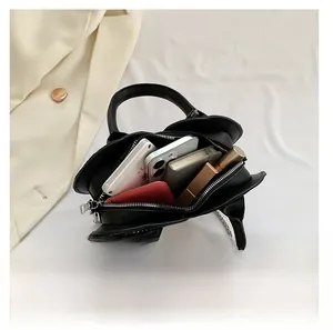 Detail view of the black heart-shaped bag interior showing capacity for daily essentials