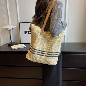 Retro woven straw tote bag with black stripes and brown leather shoulder strap