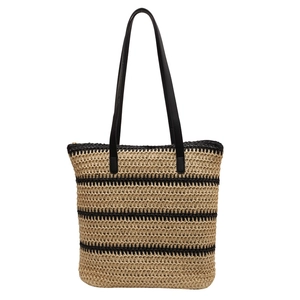 Woven straw tote bag with black stripes and long leather handles for summer beach travel