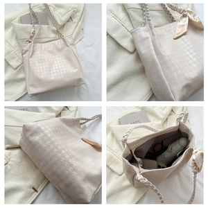 Detail of houndstooth tote bag showing spacious interior with woven strap and silk scarf