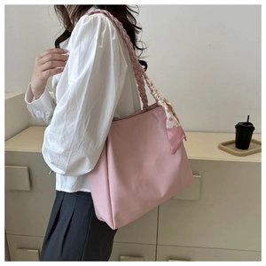 Pink large tote bag with woven handles and a decorative floral silk scarf detail
